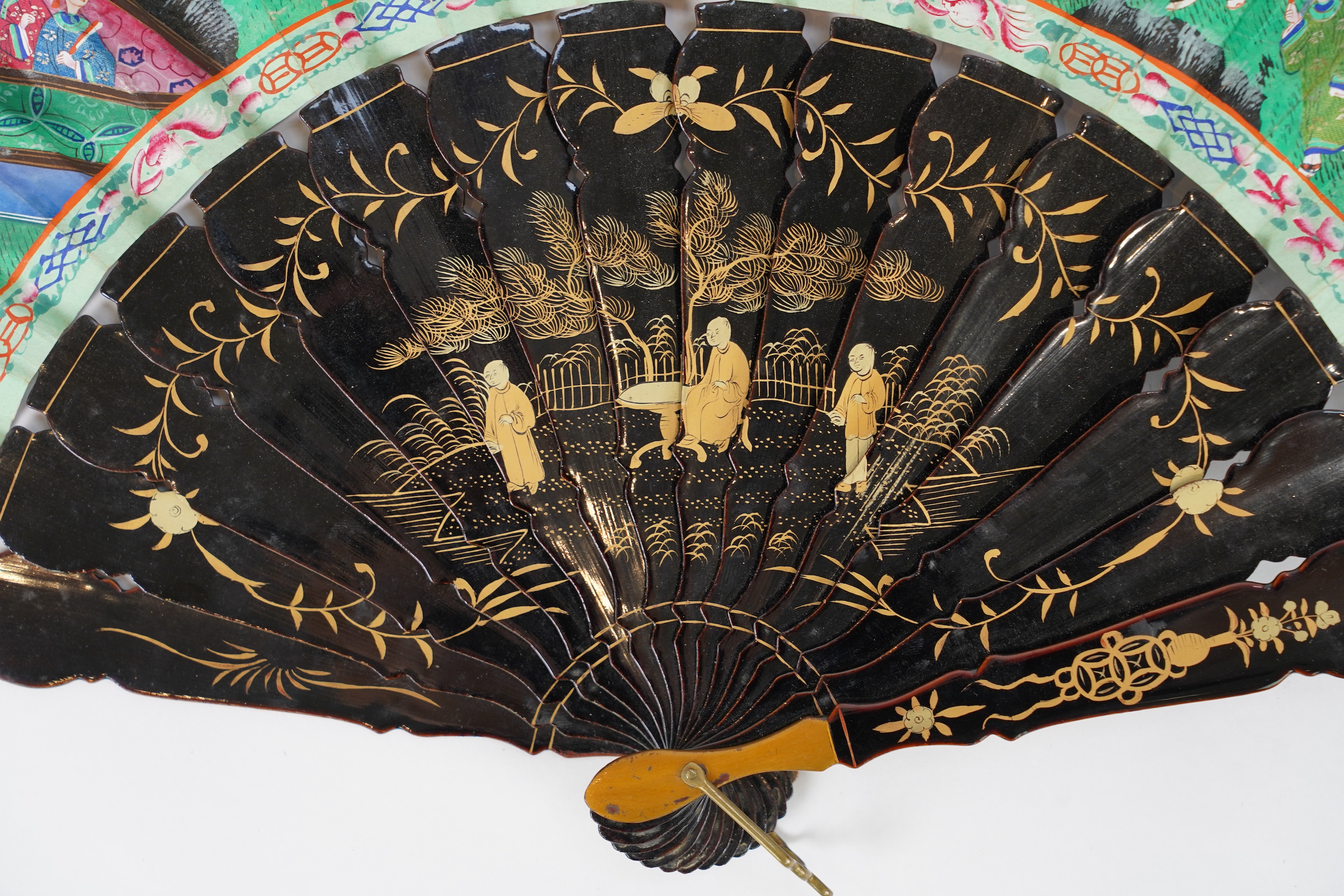 Three Chinese gilt-decorated black lacquer and painted leaf fans, 19th century